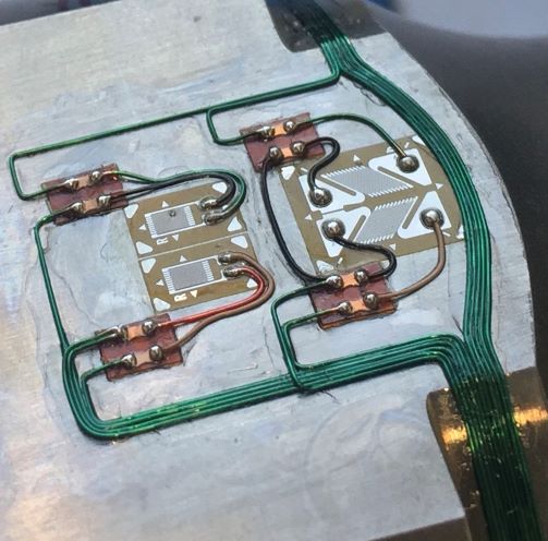 Strain gauges, wiring and soldered connections on a metal structure.